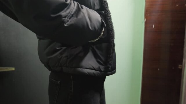 Person hesitates slightly before walking away. Student pauses momentarily before making their exit from hallway. Person hesitates for moment prior to departing through cold corridor