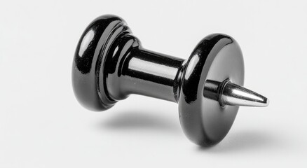 Obraz premium Shiny black tack with pointed metal pin on a white surface