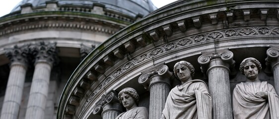 Fototapeta premium A close view of historic stone architecture featuring intricate sculptures and columns, illustrating the beauty and craftsmanship of classical design in historical buildings.