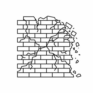 Cracked brick wall with broken pieces.