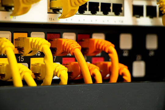 Ethernet cable connected with network switch and patch panel. Network, technology or data center concept.