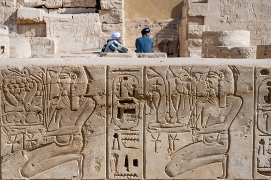 Close up details of ancient Egyptian history shown in reliefs and hieroglyphs inside Medinat Habu, the ancient Egyptian Mortuary Temple of Ramesses III on the West Bank of The Nile, Luxor, Egypt.