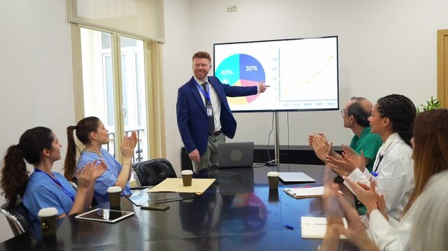 Businessman making a presentation about medical results to a team of doctors, nurses, and surgeons in a conference room