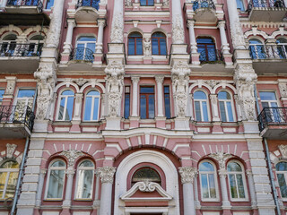 Fototapeta premium Historic Pink Facade with Ornate Balconies in Kyiv Ukraine