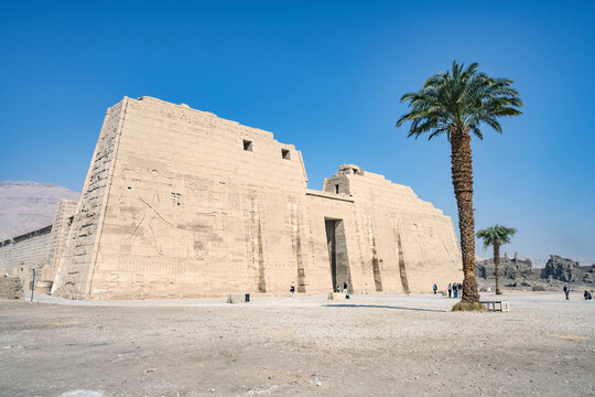 The dramatic fortress style High Gates at the entrance of Medinet Habu, the Ancient Egyptian Mortuary Temple of Ramesses III on the West Bank of The Nile, Luxor, Egypt.