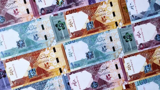 Qatar paper money, the Qatari riyal as a tool for financial transactions and trade. Qatari money as a business background for your design