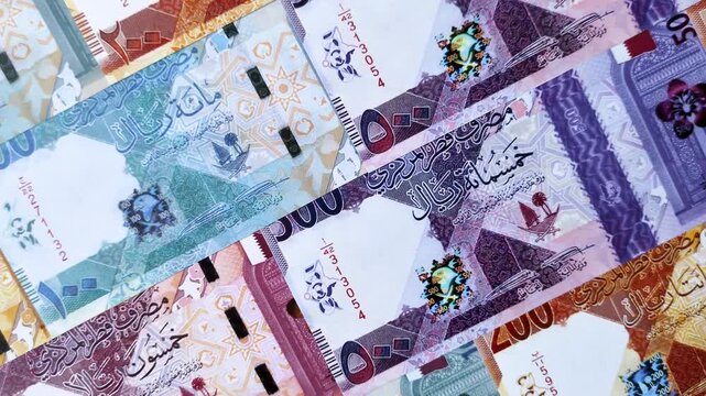 Qatar paper money, the Qatari riyal as a tool for financial transactions and trade. Qatari money as a business background for your design