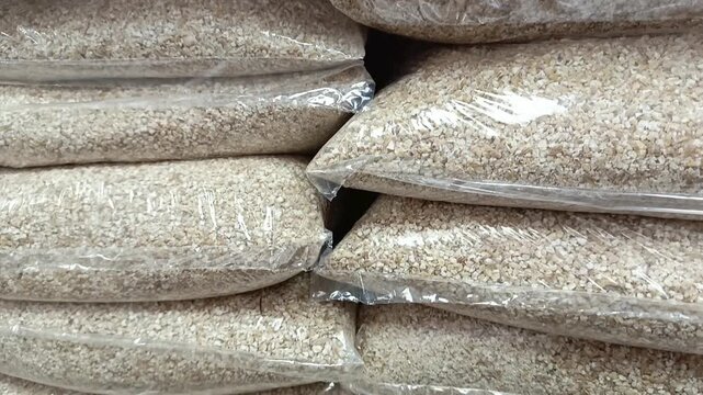Barley groats in a package on the shelf in the store. Grocery on the counter in the supermarket