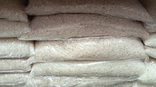 rice in transparent bags, packaging on the shelf in the supermarket. Grocery. trade