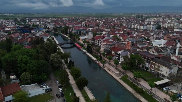 4K drone flying forward and panning left along the Black Drin River in Struga, North Macedonia