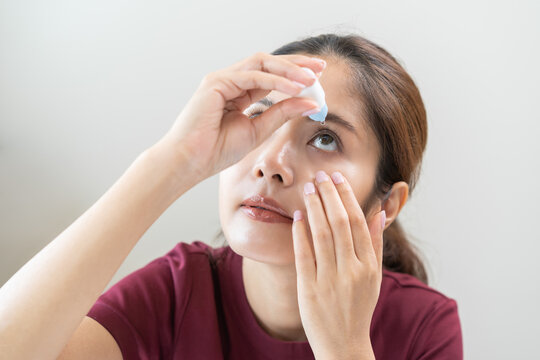 Health care concept, eye problem asian young woman applying, using medical eye drops to treat dry eye and irritation, suffering from irritated eye dry eyes or inflammation, allergy optical symptom.