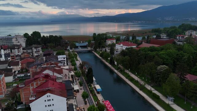 4K drone parallax pan of the Black Drin River mouth flowing out of Lake Ohrid in Struga, North Macedonia