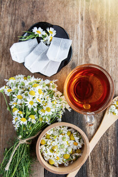 cup of herbal chamomile tea with fresh daisy flowers on wooden background. doctor treatment and prevention of immune concept, medicine - folk, alternative, complementary, traditional medicine