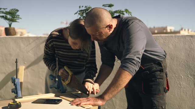 Father teaching teenage daughter woodworking skills outdoors, highlighting equal opportunities in practical education, empowerment, and breaking traditional gender roles in hands-on DIY activities.