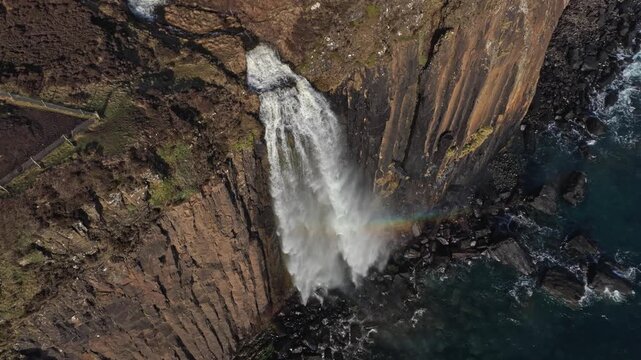 Aerial view of mealt falls and kilt rock waterfall plunging into the ocean