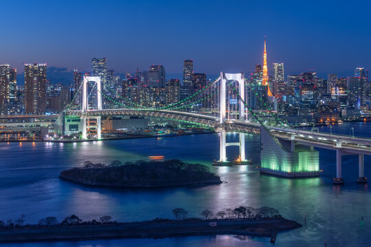 Tokyo cityscape at night with view of Rainbow Bridge and Tokyo Bay