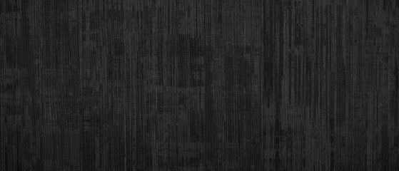 Fototapeta premium Close-up view of black textured surface. Vertical lines create subtle pattern. Monochrome effect emphasizes texture. Ideal for backgrounds or design elements
