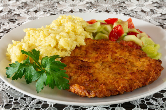kotlet schabowy z ryżem, og&oacute;rkiem i pomidorem