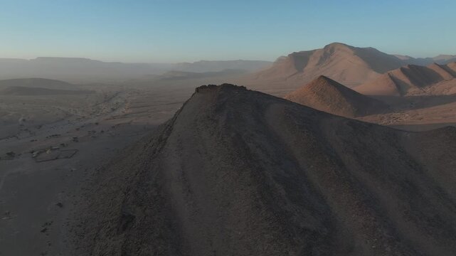 Aerial View of Desert Ridge with Ruins at Sunrise

