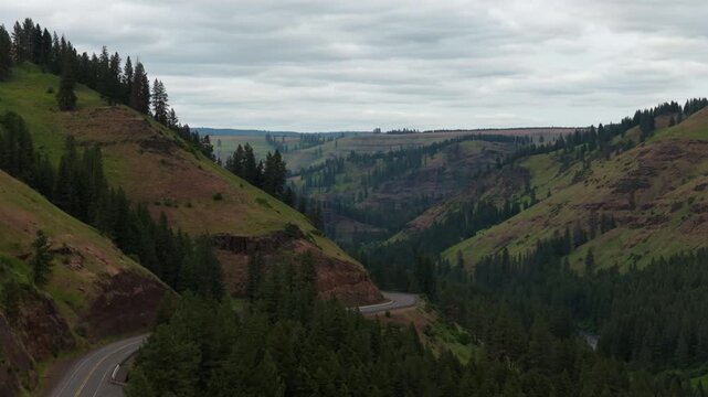 Aerial of Highway 82 along Minam River in east Oregon in Wallowa Mountains in spring