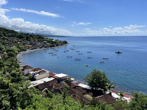 Amed fishing village bay in Bali, Indonesia, with traditional jukung outrigger boats moored on calm turquoise water