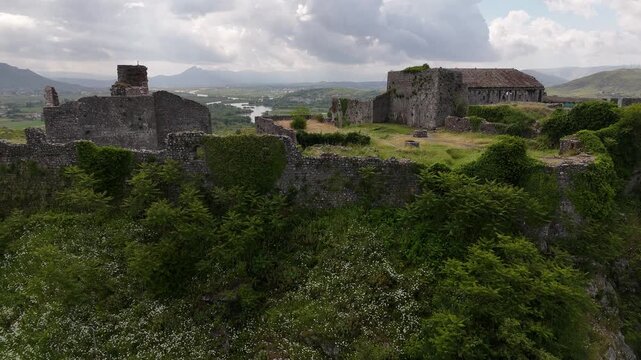 4K drone tracking flight over ruined medieval stone buildings and watchtower at Rozafa Castle, Albania