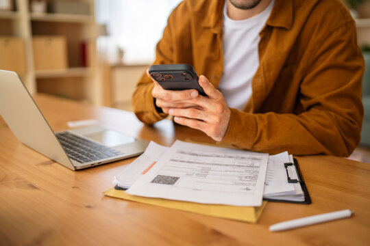 Man scanning qr code on bill for online payment