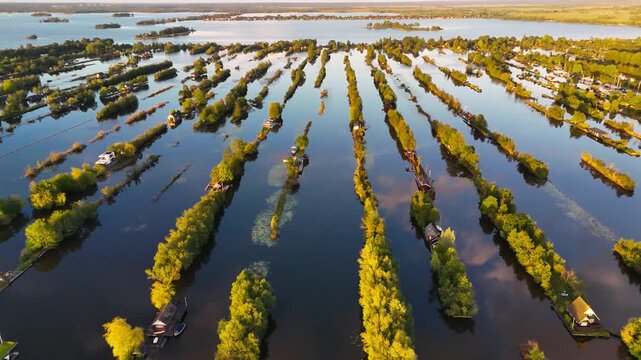 Aerial drone view the harbour of Scheendijk Loosdrechtse Plassen, a floating village in the Netherlands at sunset. High quality 4k footage