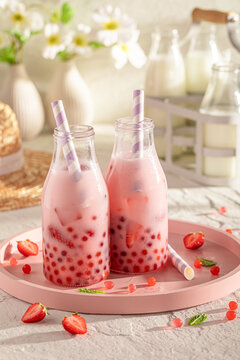 Homemade and fruity strawberry bubble tea with berries and milk.