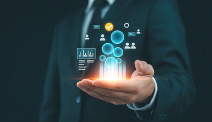Fototapeta premium Businessman holding data analytics hologram, business intelligence, market research, financial reports, digital marketing, corporate management, customer relationship management