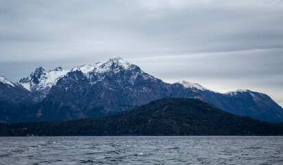 Fototapeta premium snow covered mountains Winter with snow on Lake Nahuel Huapi in San Carlos de Bariloche, Argentina.