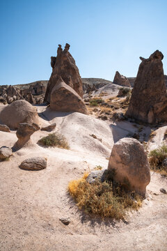 Vertical shot of rock formations and barren landscape in Devrent Valley in Cappadocia on a summer day.