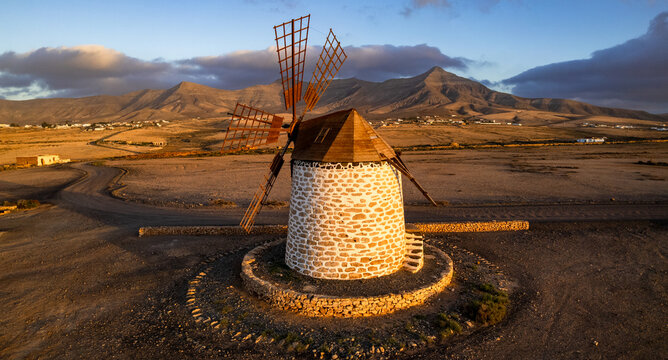 Canary Islands Spain. authentic Tefia Windmill Sunset Fuerteventura Aerial Drone View Deserted Landscape Golden Hour Red Volcanic Mountains Backdrop Panoramic Photography Scenic Heritage Site