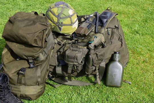 Military equipment on the grass: backpack, helmet, flask. Equipment of the Swedish army.