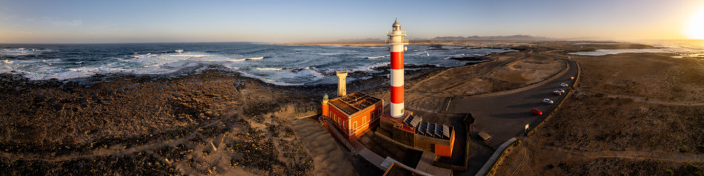 Fuerteventura El Cotillo lighthouse panorama 16K golden sunset ocean background black volcanic soil, Canary Islands Spain scenic travel destination wide format print