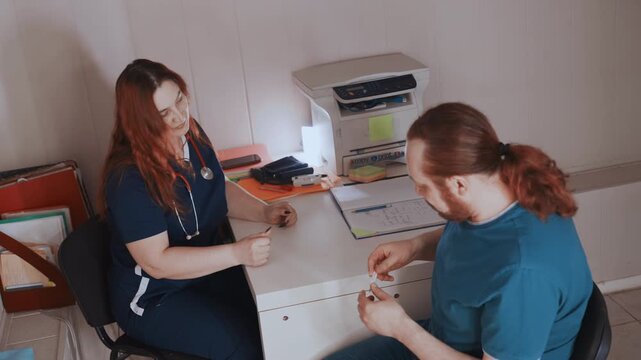 Medical professionals demonstrate device use and conduct thorough patient assessment. Emergency medical team reviews medication protocols and performs device demonstrations with patient engagement