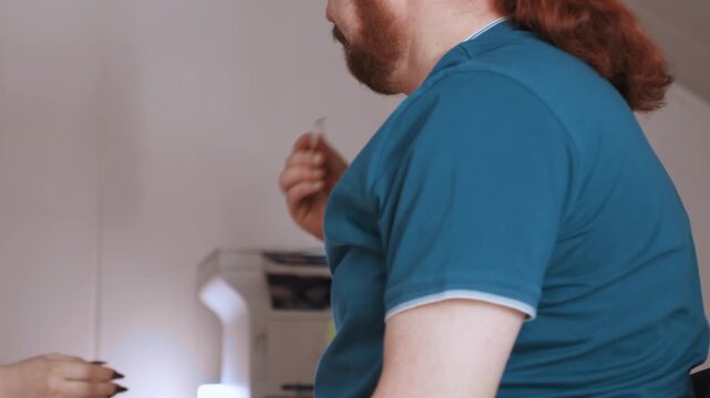 Device transfer discussion. Nurse and patient exchange tense expressions. Tense exchange during device handover and paperwork review. Nurse and patient engage in tense exchanges during consent process