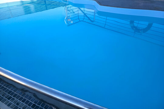 Pool water mirrors the clear sky