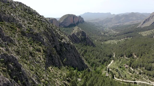 Aerial view of Sella mountains with its spectacular granite cliffs and Mediterranean pine forests, Spain. 