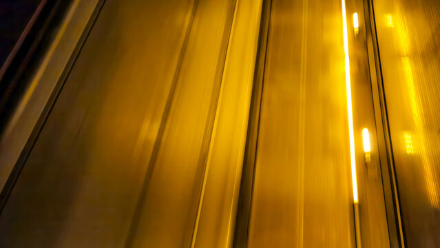abstract golden motion blur at night representing high-speed public transit and urban commuter transportation