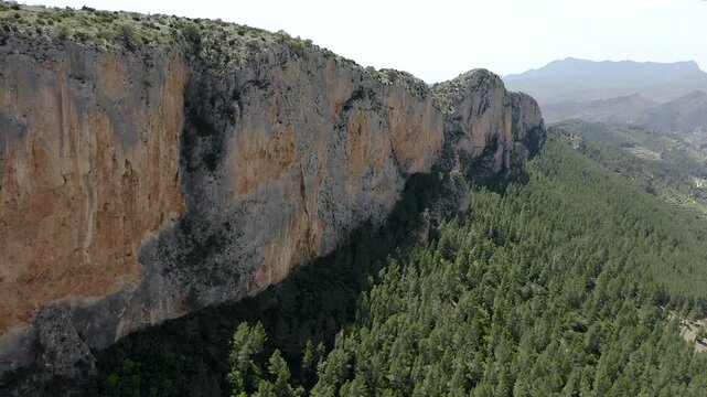 Aerial view of Sella mountains with its spectacular granite cliffs and Mediterranean pine forests, Spain. 