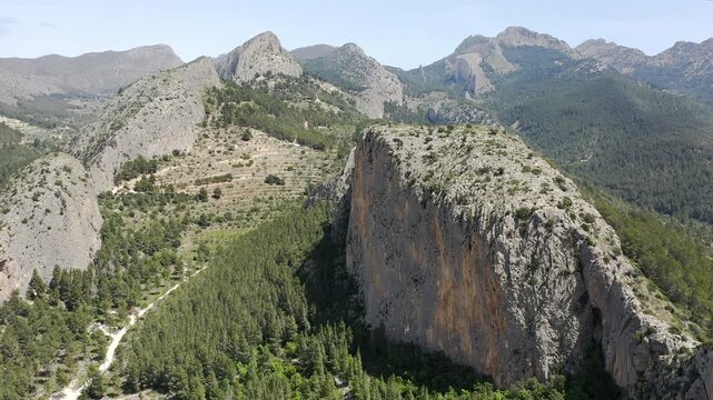 Aerial view of Sella mountains with its spectacular granite cliffs and Mediterranean pine forests, Spain. 