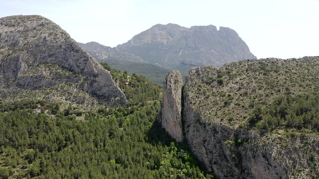 Aerial view of Sella mountains with its spectacular granite cliffs and Mediterranean pine forests, Spain. 