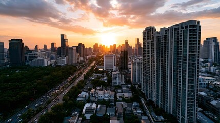 Fototapeta premium A dramatic aerial view of a modern cityscape bathed in the warm glow of the golden hour