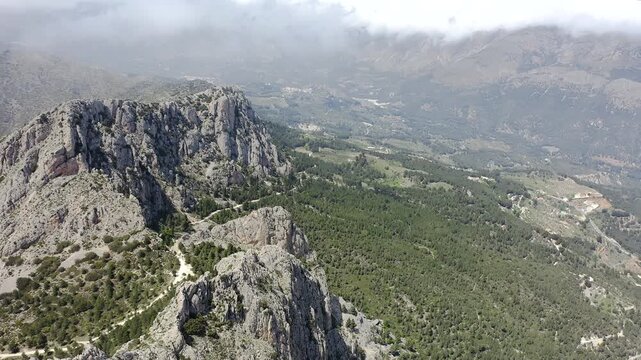 Aerial view of Sella mountains with its spectacular granite cliffs and Mediterranean pine forests, Spain. 