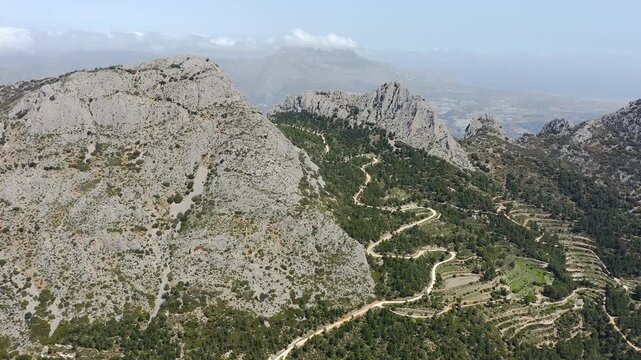 Aerial view of Sella mountains with its spectacular granite cliffs and Mediterranean pine forests, Spain. 
