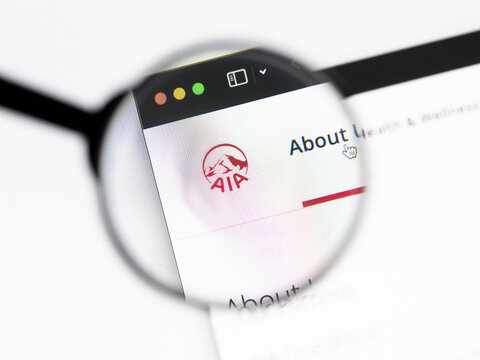 Milan, Italy 2026, 20 Apr Closeup of AIA Group website on a laptop screen. AIA Group logo under a magnifying glass.