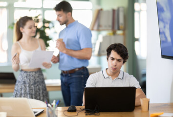 Fototapeta premium Man regional representative office staff working with laptop, brunch of international company, editorial staff of journal, scientific bureau, staff of the higher educational institution