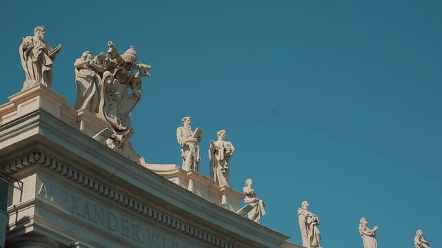  A panning shot of the impressive St. Peter's Square Colonnade in Vatican City, showing the giant columns and tourists strolling through the majestic covered architectural passage.

