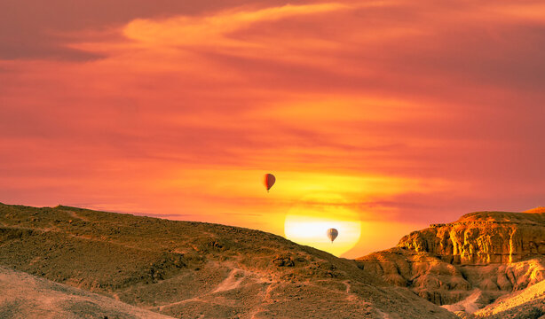 Hot air billon over mountain in sunrise